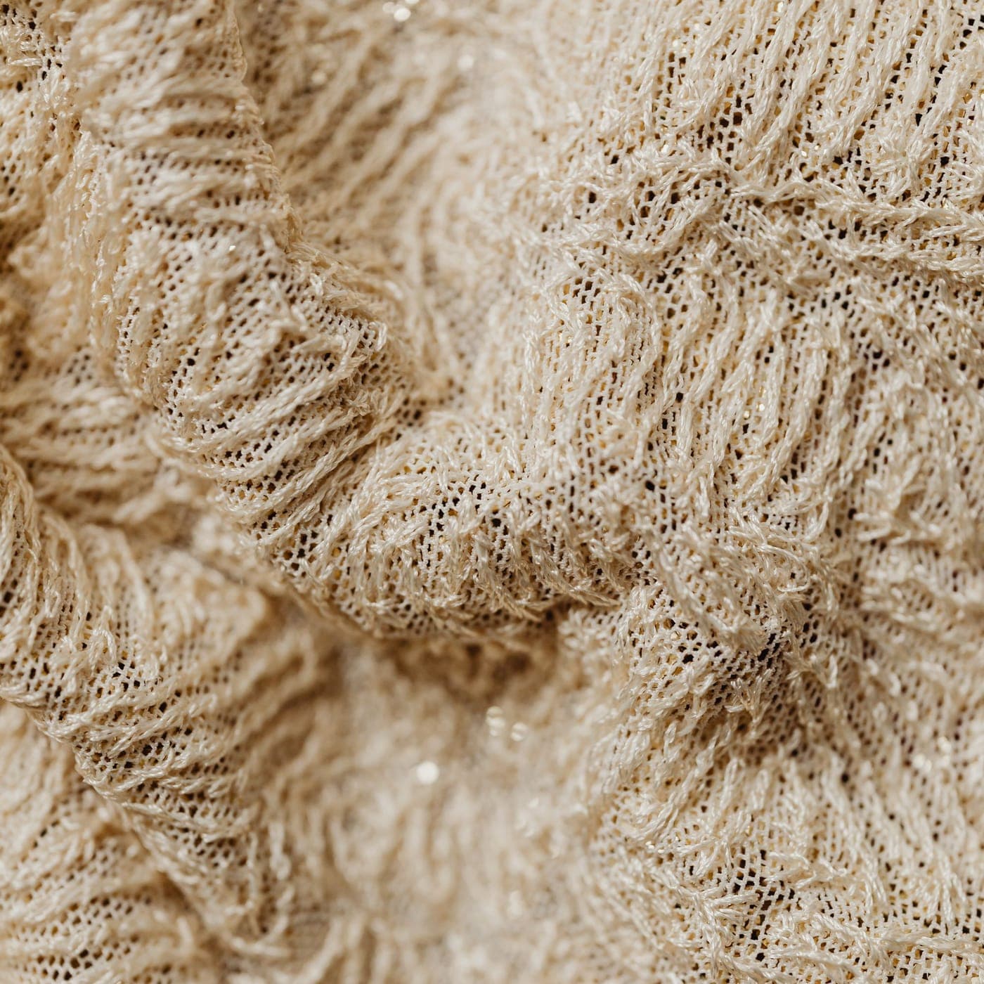 Close-up of cream French terry showing the looped inner face of the knit
